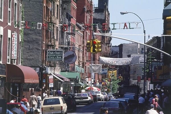 USA, New York, Manhattan, Lower East Side, busy street with Italian restaurants and shops, banner above reading Welcome to Little Italy