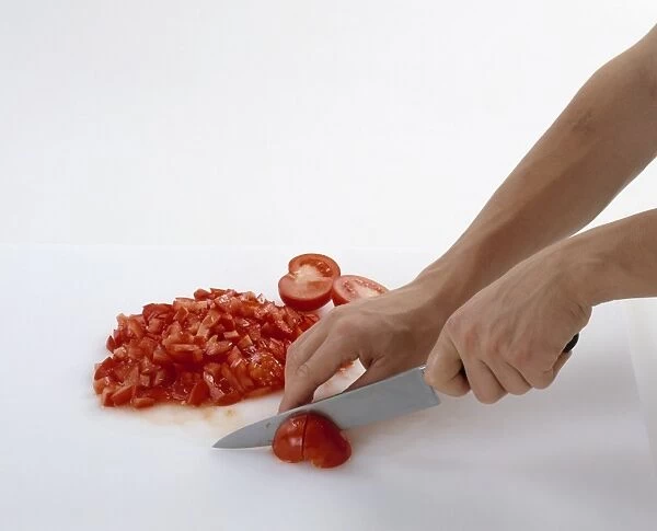 Using kitchen knife to slice and chop tomatoes