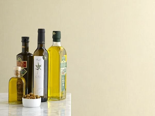 Various bottles of spanish olive oils and small bowl of olives