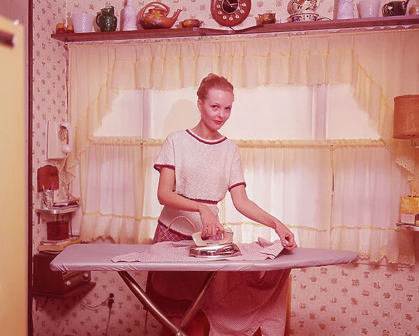 Woman ironing clothes in 1970s home