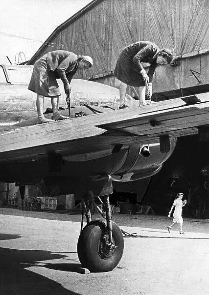 Two women working on the metal covering of a wing of a soviet military plane during world war 2, september 1944