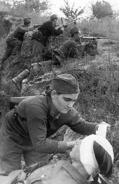 World war 2, 18 year old militsa belobaba, a stretcher-bearer of a yugoslavian partisan detachment, bandaging a wounded man