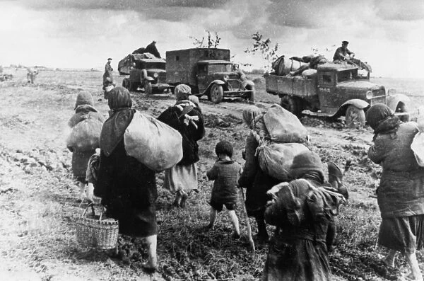 World war 2, civilian refugees walking east, past red army troops heading west to the front to counter the german advances in july 1941