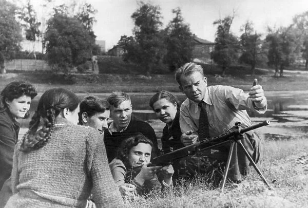 World war 2, george glazkov (right) on the spartak team teaches the youth to handle machine guns and anti-tank rifles
