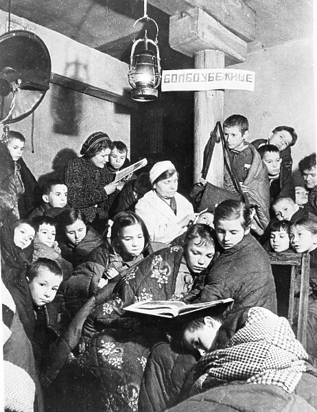 world war ll: leningrad during the blockade, during an air raid alert children take cover in the nearest bomb shelter