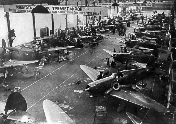 Yak-1 fighter planes being built in the assembly shop of a soviet aircraft factory during world war ll