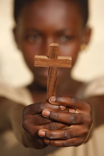 Young African christian holding a cross