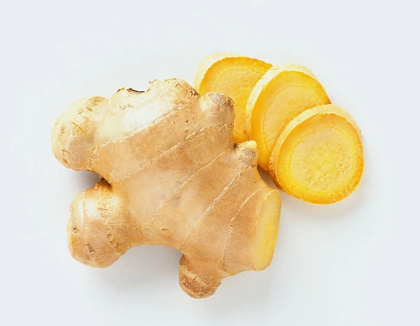 Zingiber officinale, lump of Ginger and three round slices, view from above