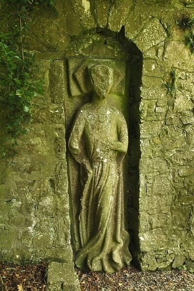 Sculpted figure in the old city wall
