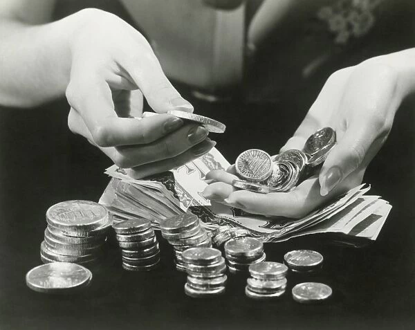 Woman counting change, close up of hands