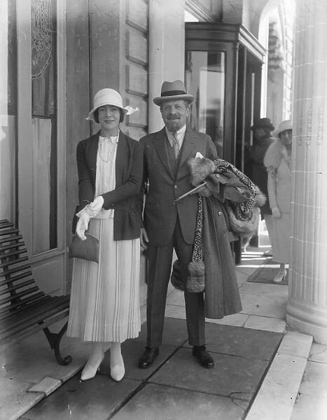 Popular stage star at Cannes Mrs Raymond Pollak with her husband at Cannes. She