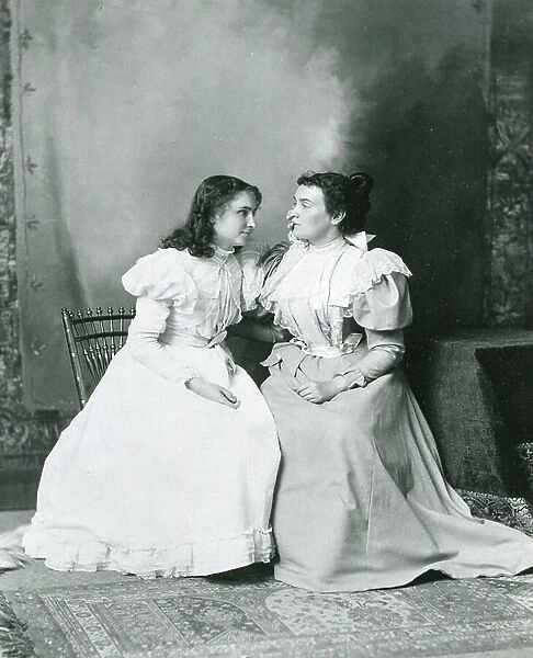 1897 - Deaf and Blind Helen Keller (left) listens to Anne Sullivan's words in this photo. Anne Sullivan's brilliant success as Keller's teacher set standards for all who work with the deaf and blind (b / w photo)
