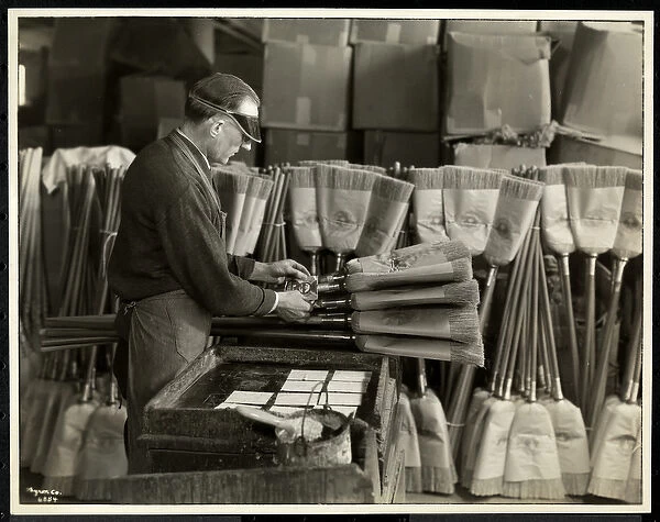 Blind man labeling brooms at the Bourne Memorial Building, New York