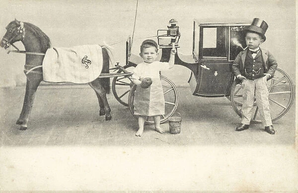 Boys dressed up to resemble dwarfs alongside toy horse and carriage (b  /  w photo)