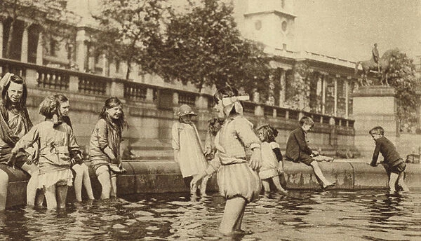 Children enjoying a paddle in Trafalgar Square during a heatwave (b  /  w photo)