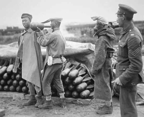 Chinese labourers working for the British Army in France stacking aerial bombs at an