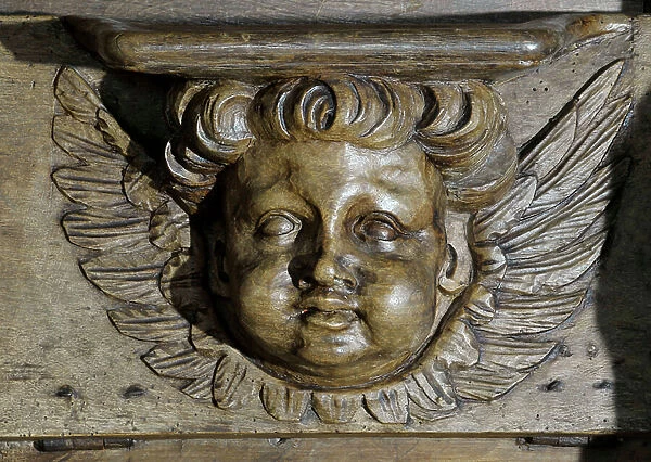 Chubby angelot head Boiseries of the 17th century Detail of the stalls of the church of the Clunisian Prieure Sainte-Marie (Sainte Marie) founded in the 11th century, Moirax, Lot et Garonne