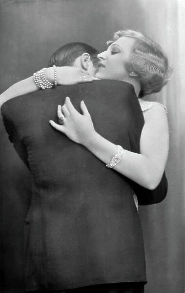 A couple kissing passionately on pink background, 1910 about Historical photo, kissing couple, ca. 1910