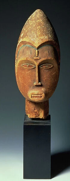 Dance head-dress showing scarification in relief and light blue-green colouration to the eyes and brow from the West African Ibo tribe (wood)