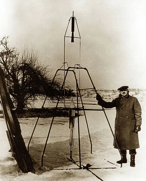 Dr Robert H. Goddard next to a liquid oxygen-gasoline rocket, 1926