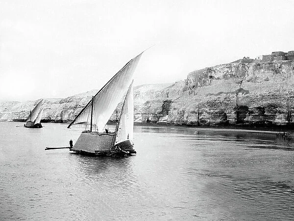 Egypt: Cook cruise, Nile side, convoy of transport felouques along the cliff bordering the Nile, 1900