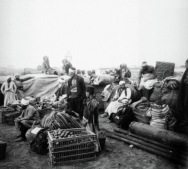 Egypt: On the shore of the red sea, on the coast, pelerins with goods and food reserves waiting in the port of a small village, the boat to take them to Mecca, 1899