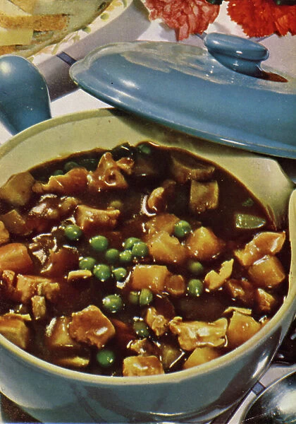 English cookery, 1950s: Meat stew in a casserole (colour photo)