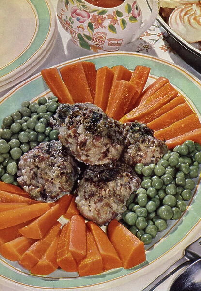 English cookery, 1950s: Savoury faggots with vegetables (colour photo)