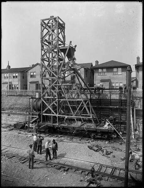 Erecting a concrete mixer at 1910 63rd Street, Brooklyn, c. 1914 (b  /  w photo)