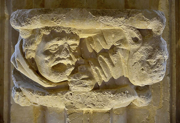 Figure of frightened monk - sculpted capital of the Abbey Notre Dame de la Nativite (consecrated in 1154) of Cadouin (Dordogne, Perigord)