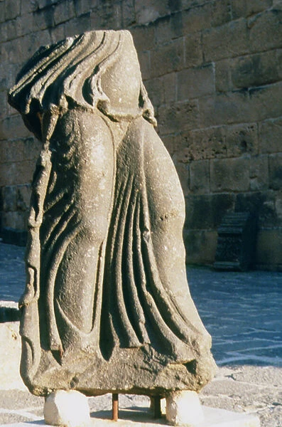 Fragment of a sculpture of a standing woman (basalt)