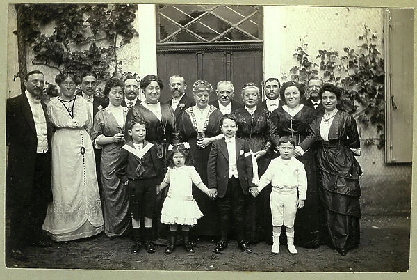 France: Group photo of a family for the first communion of a child, 1900