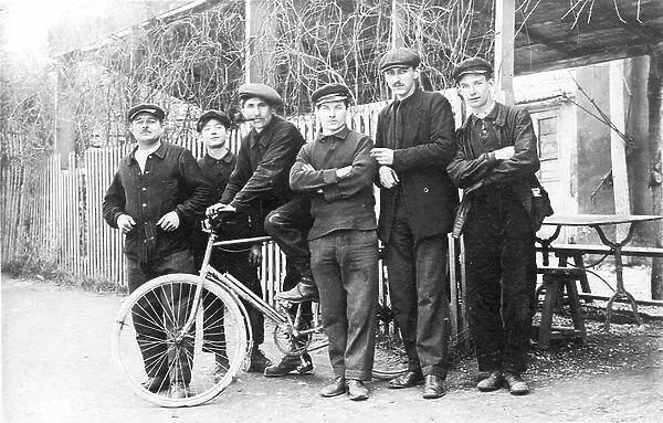France: A group of workers with a bicycle in front of a drinking flow, 1910