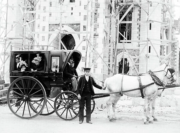 France: hippomobile car in front of a Chateau under construction with coachman in livree and women in hat, 1895
