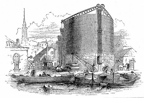 General exterior view of City of London Gasworks, showing gasometers and coal barges moored at the quay. Wood engraving, 1876