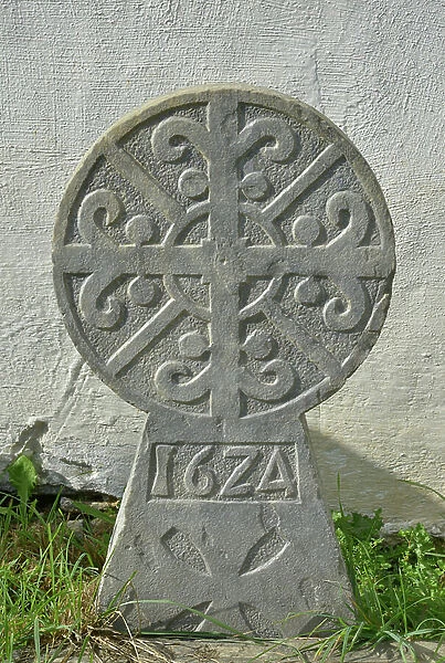 Grave stone of 1624 - Discoidale stele of a traditional Basque cemetery - Chapel Saint Cyprien (12th century) in Ascombeguy (Pyrenees Atlantiques, Aquitaine)