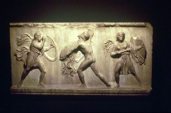 Greek warrior fighting Amazons, the female warriors. 8th-5th century bc (limestone relief)