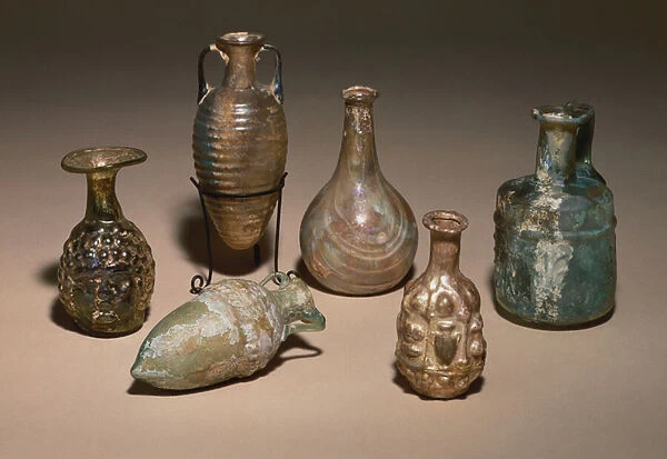 A group of delicate Roman blown and mould blown glass cosmetics flasks
