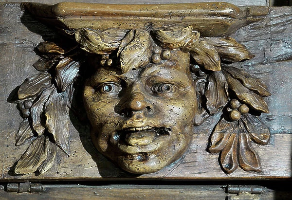 Head of character links to the Dionysian cult Boiseries of the 17th century Detail of the stalls of the church of the Clunisian Prioress Sainte-Marie (Sainte Marie) founded in the 11th century, Moirax, Lot et Garonne