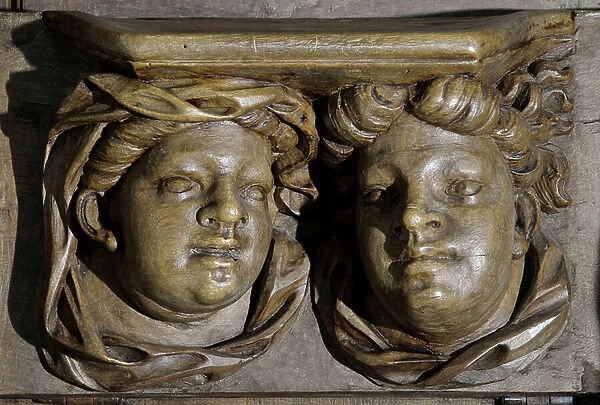 Heads of chubby characters Woodwork of the 17th century Detail of the stalls of the church of the Clunisian Prioress Sainte-Marie (Sainte Marie) founded in the 11th century, Moirax, Lot et Garonne