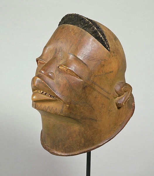 Helmet mask with incised scarification and ridged crest with attached hair from the East African tribe of the Makonde (wood, hair)