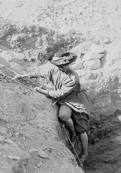 Hilda Petrie (nee Urlin) descending by rope ladder into a tomb shaft