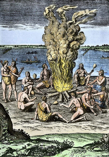 History of Indigenous Peoples: Indians of America around a fire on the coasts of North Carolina, 16th century.Colour engraving