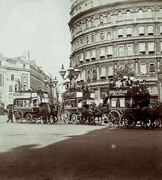 Horse-drawn streetcars, passing in front of the Grand Hotel in Trafalgar Square, in London