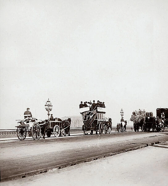 Horse-drawn wagons, carraiges and streetcars, crossing Waterloo Bridge in London