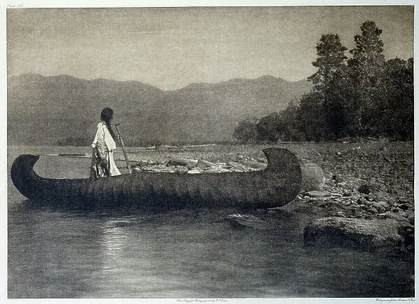 Indians of America: an Indian on a canoe boat in southern Flathead Lake, Montana