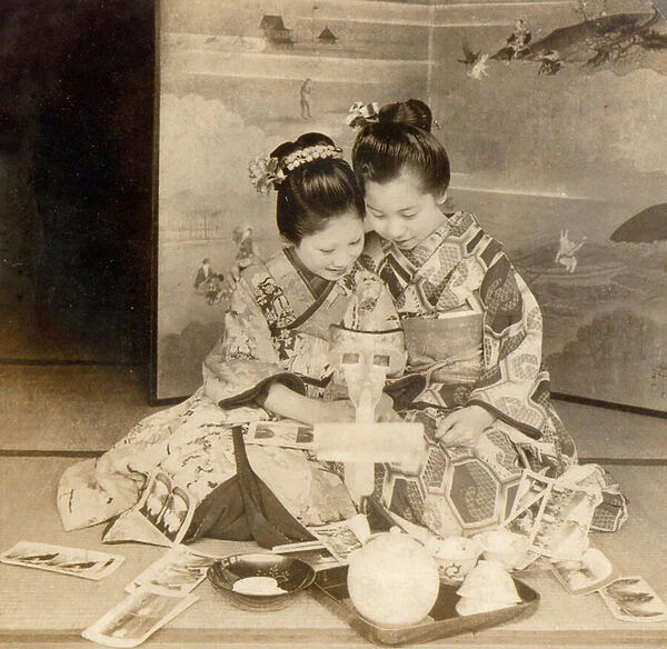 Japanese girls using a stereoscope viewer with stereographic cards, 1899 (photo)