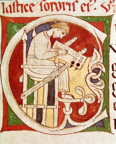 Letter C adorned with a monk writing on a desk. Miniature from '