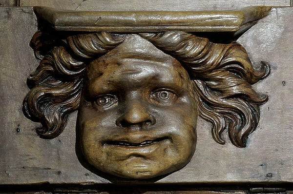Little chubby character with the grotesque expression Boiseries of the 17th century Detail of the stalls of the church of the Clunisian Prioress Sainte-Marie (Sainte Marie) founded in the 11th century, Moirax, Lot et Garonne