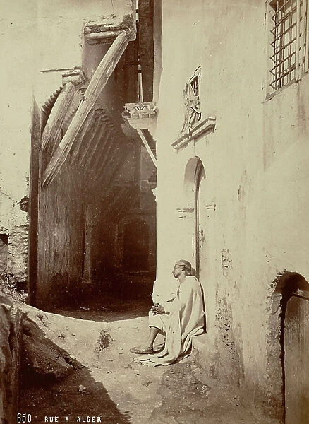 A man asleep in a doorway of an alley, in Algiers, 1880 (print on double-weight paper)